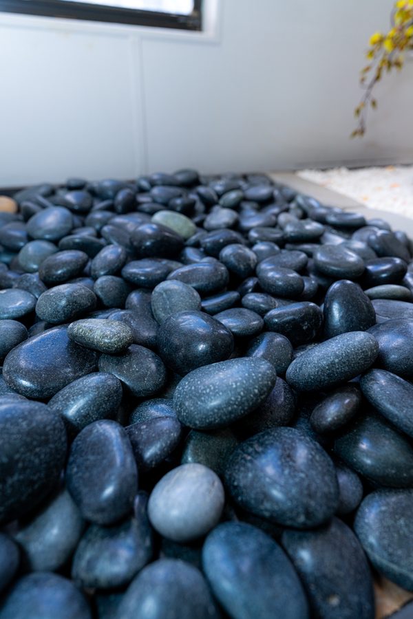 Close-up of glossy black polished pebbles