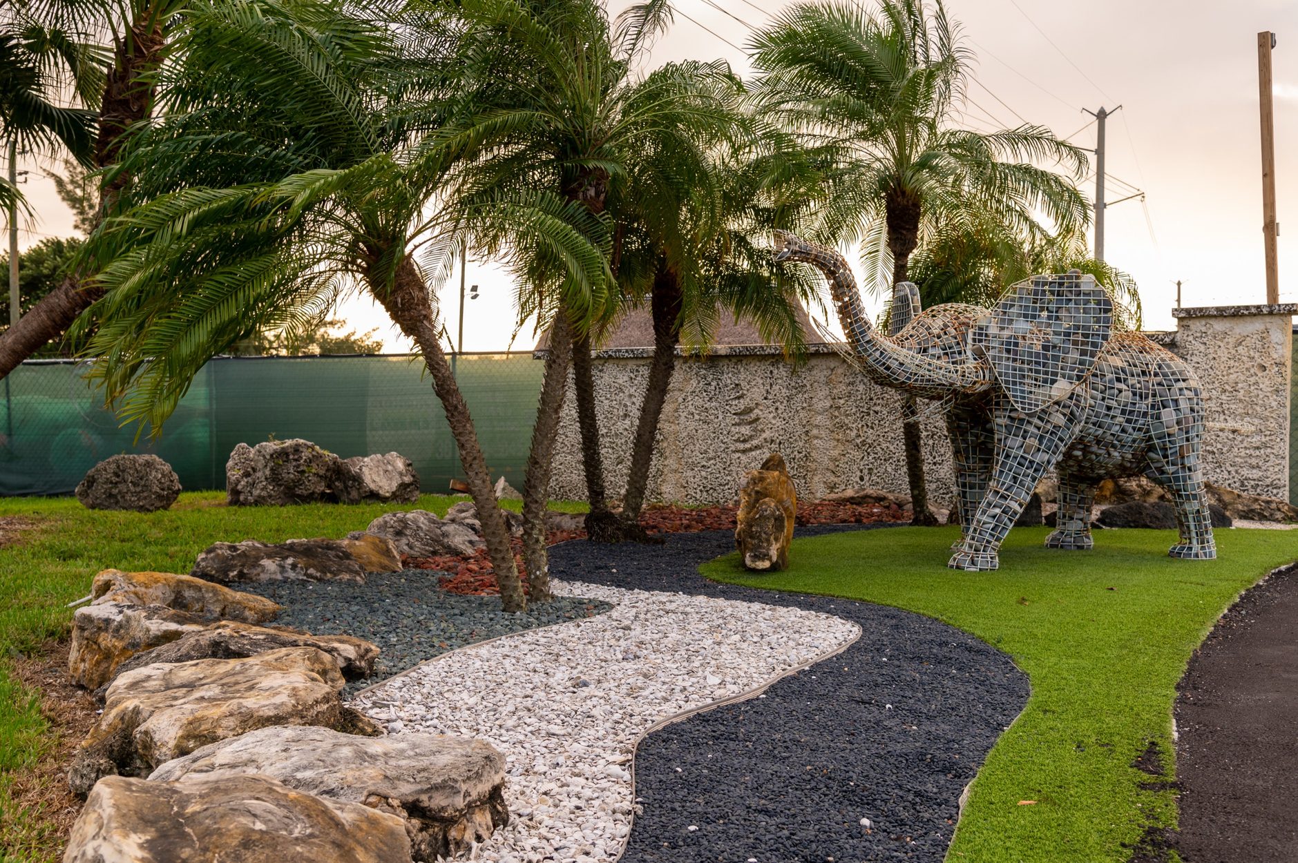 Olimar Stone display garden with palms, boulders and a stone mosaic elephant sculpture