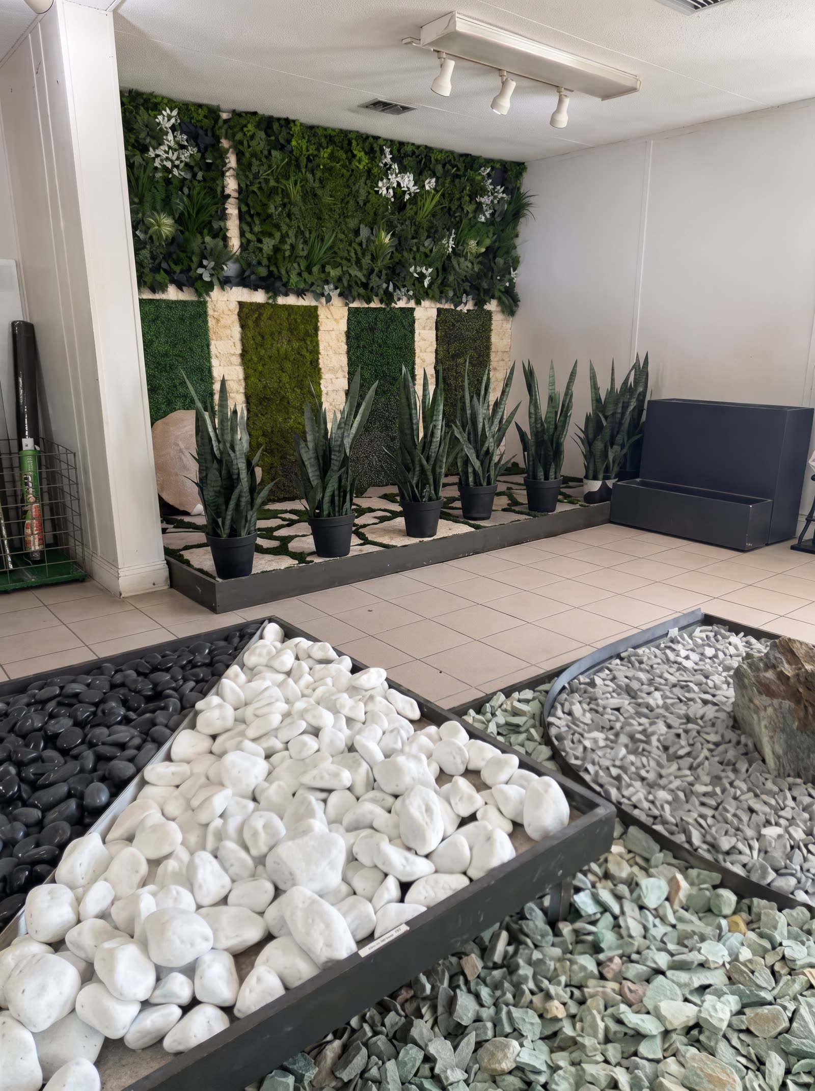 Olimar Stone showroom with a living moss wall and decorative pebble displays